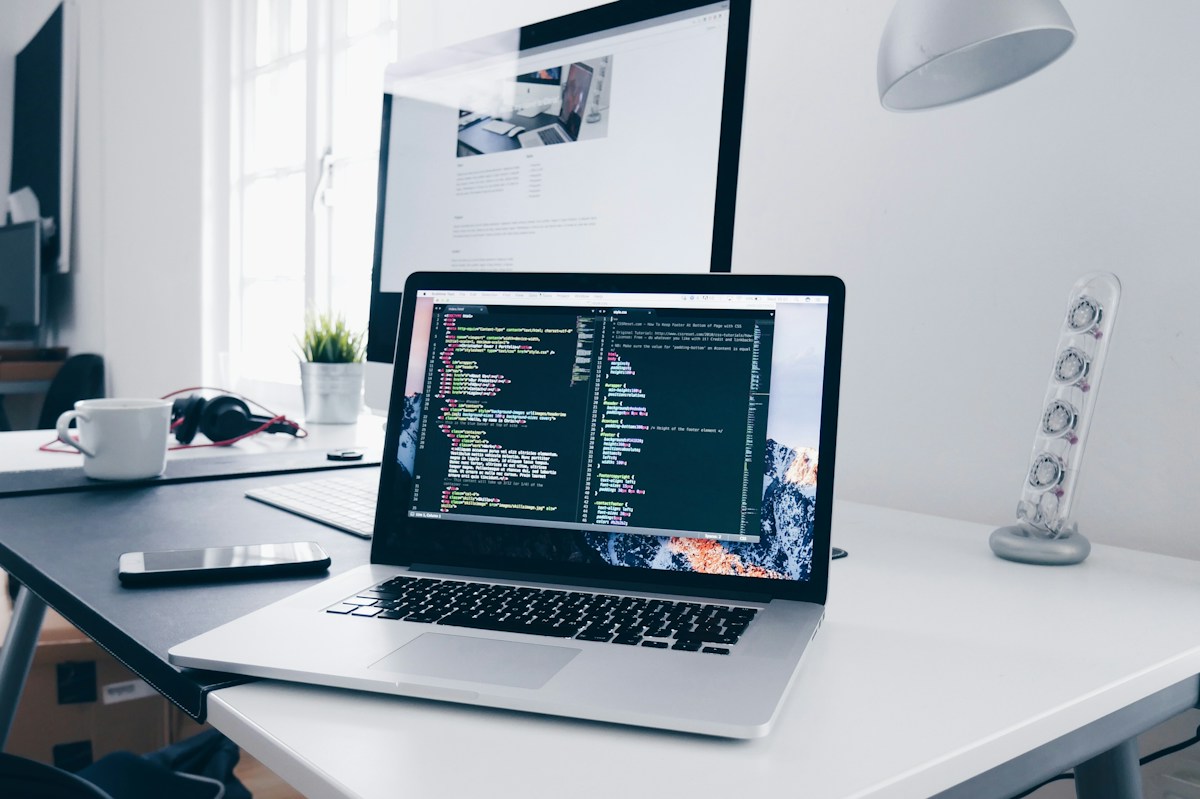 Laptop and monitor in a light home workspace