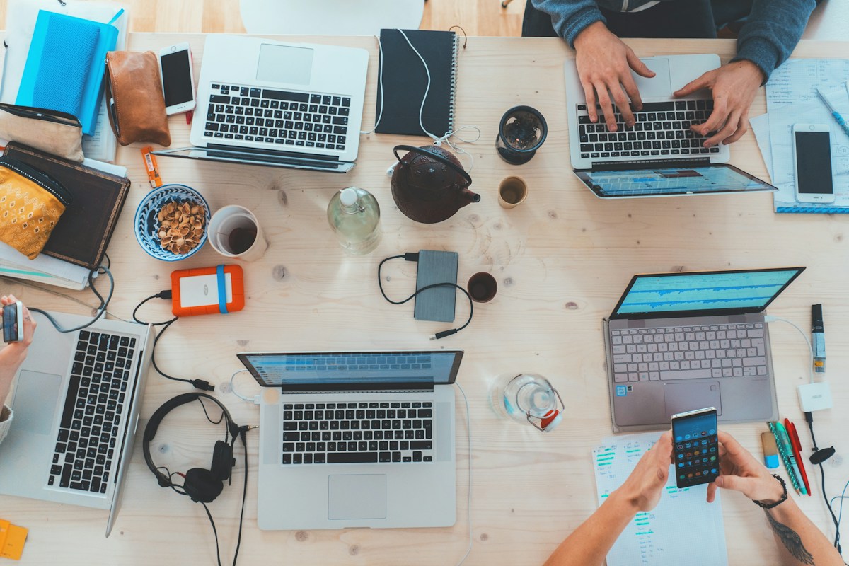 Shared worktable with laptops and everyday accessories