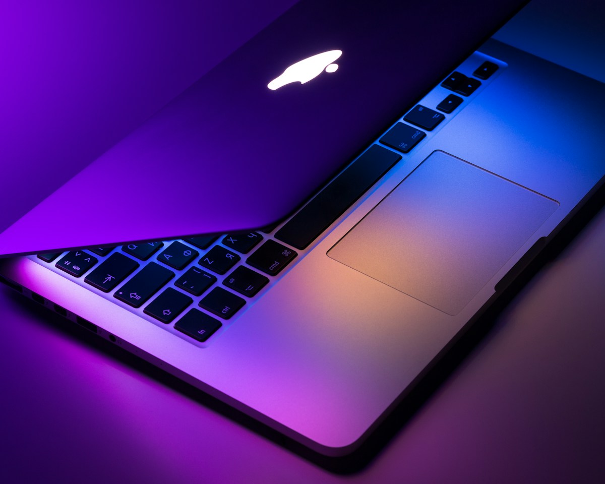Laptop on a desk under purple evening light