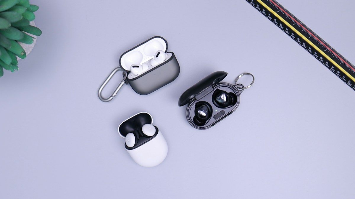 Wireless earbuds and charging cases on a tabletop