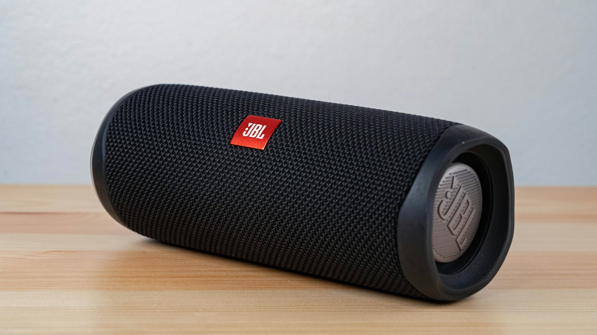Portable wireless speaker on a wooden surface