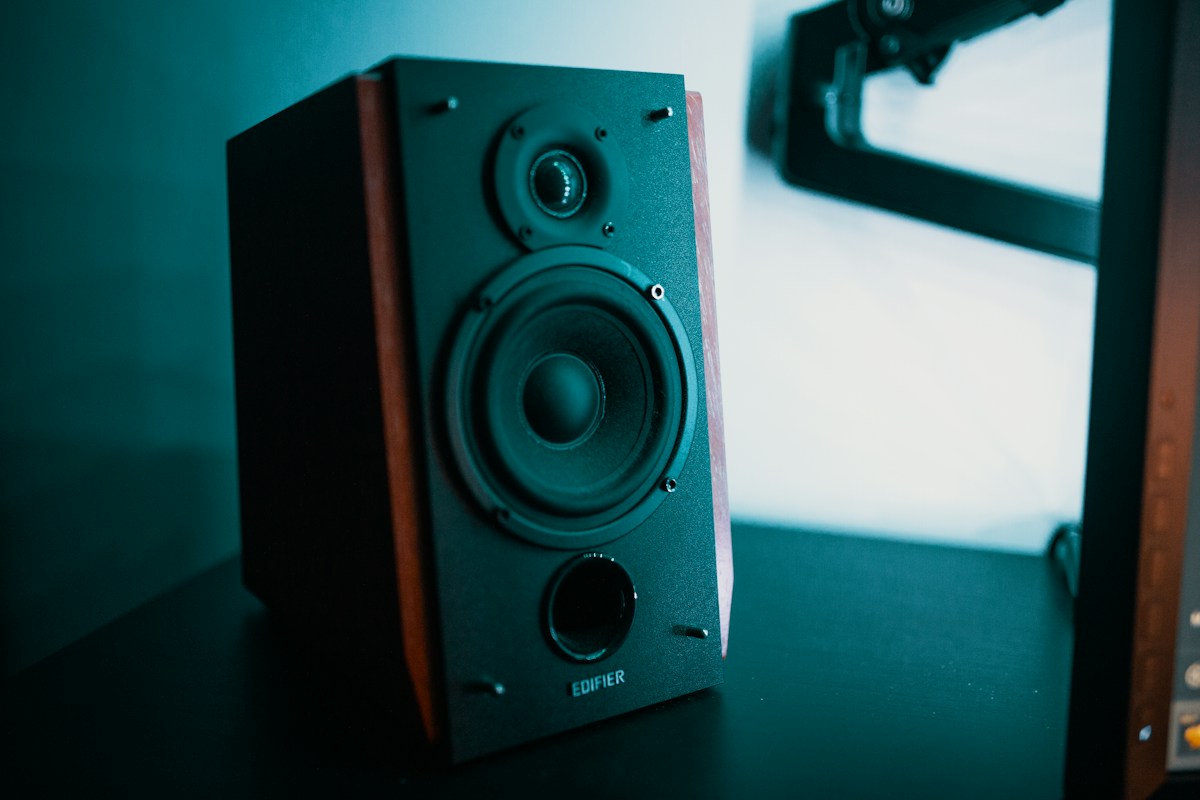 Compact speaker beside a monitor