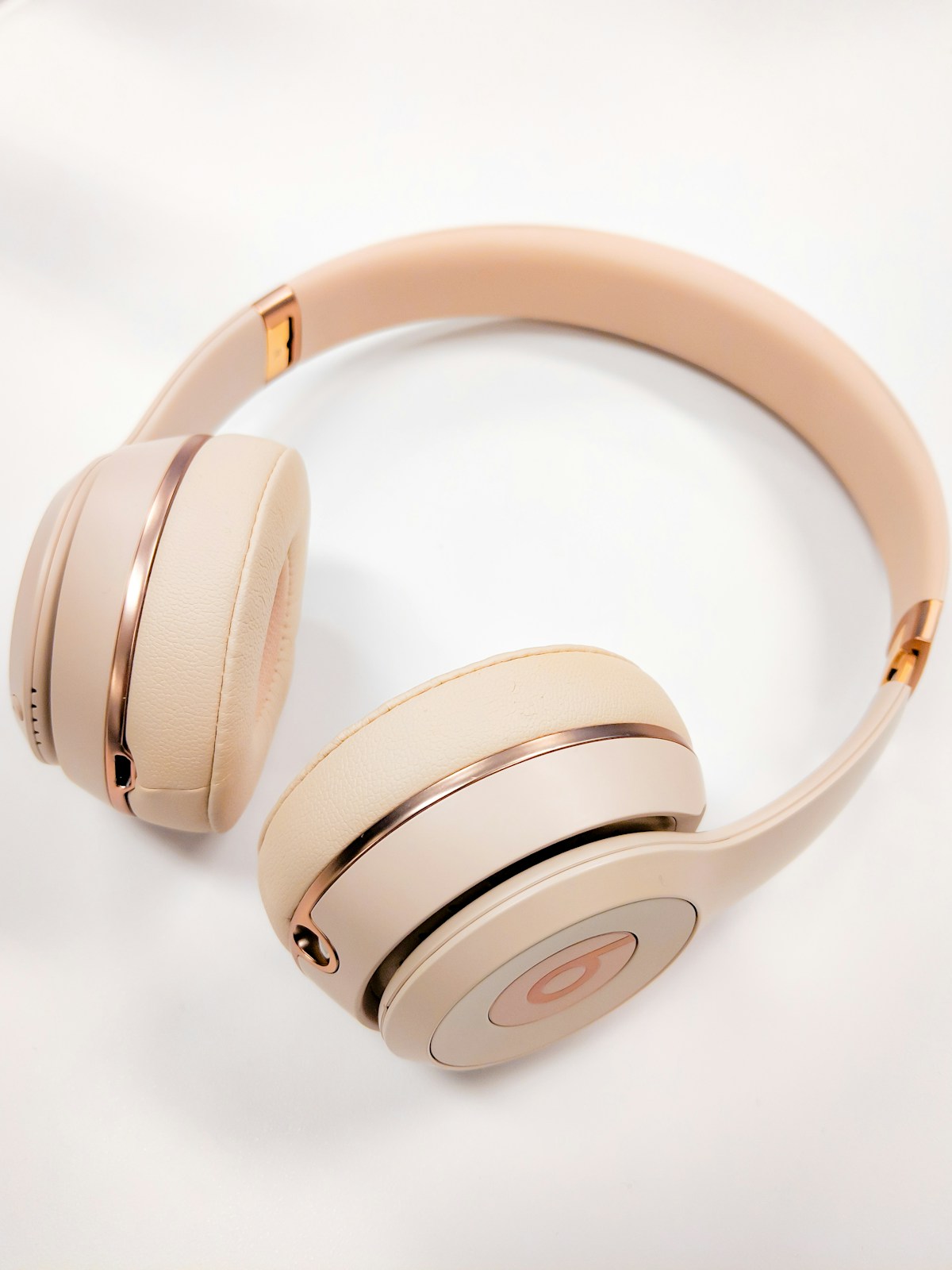 Cream-colored headphones on a light surface