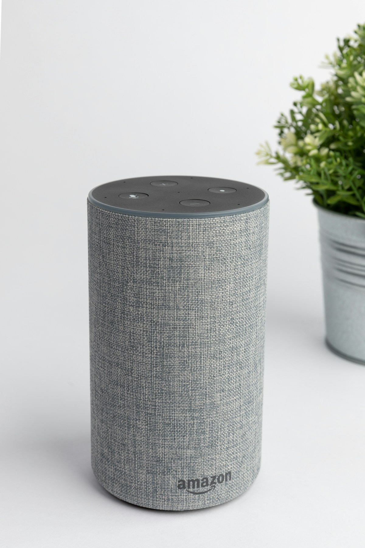 Fabric-covered smart speaker on a light surface