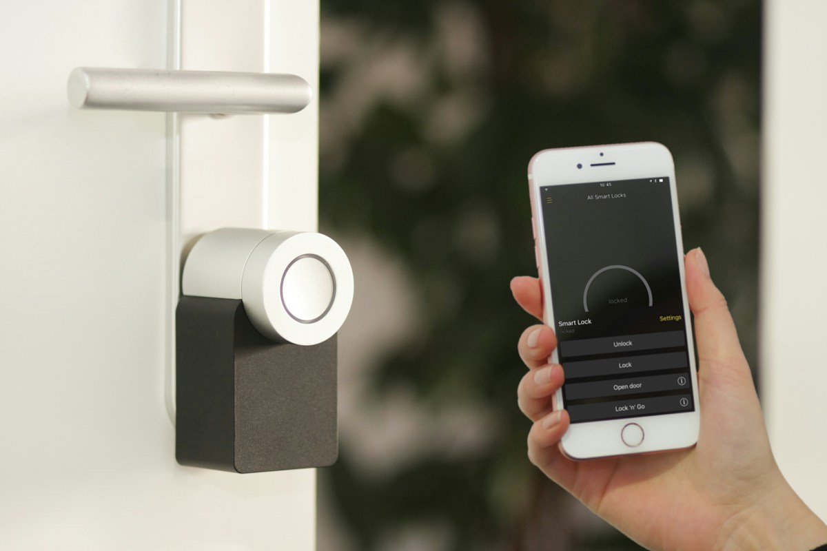A person controlling a smart door lock using a phone